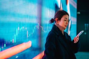 Asian businesswoman standing with a smartphone